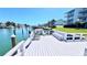 Waterfront condo features a relaxing outdoor space with chairs, bench, and table overlooking the community canal at 719 Pinellas Bayway S # 309, Tierra Verde, FL 33715