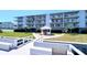 Condo exterior features multiple floors with balconies and a charming gazebo on the lawn at 719 Pinellas Bayway S # 309, Tierra Verde, FL 33715