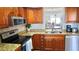 Condo kitchen has granite countertops and stainless steel appliances at 719 Pinellas Bayway S # 309, Tierra Verde, FL 33715