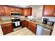 Cozy kitchen features wood cabinets, stainless steel appliances, and granite countertops at 719 Pinellas Bayway S # 309, Tierra Verde, FL 33715