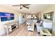 A spacious living room features an L-shaped sofa, stylish coffee table, and a large flat-screen TV at 719 Pinellas Bayway S # 309, Tierra Verde, FL 33715