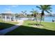 Beautiful waterfront view with palm trees and a gazebo by the boat dock at 719 Pinellas Bayway S # 309, Tierra Verde, FL 33715