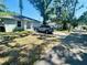 View of a single-story home with a driveway, tree, and blue sky at 724 15Th S Ave, St Petersburg, FL 33701