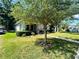 Inviting bungalow with mature trees, landscaped lawn, and a welcoming walkway leading to the front porch and entry at 724 15Th S Ave, St Petersburg, FL 33701