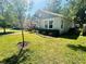 Landscaped front yard with lush green lawn, sidewalk, and a charming bungalow-style home with inviting curb appeal at 724 15Th S Ave, St Petersburg, FL 33701