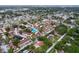 Community aerial view showcasing residential buildings, a swimming pool and well maintained landscaping at 7609 Barry Rd, Tampa, FL 33615