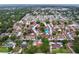 Aerial view of a quiet, established residential neighborhood with mature trees and well-maintained homes at 7609 Barry Rd, Tampa, FL 33615