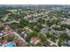 An expansive aerial view showcases a serene neighborhood with mature trees, homes and community features at 7609 Barry Rd, Tampa, FL 33615