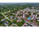 Neighborhood aerial view, showcasing residential buildings, mature trees and community landscaping at 7609 Barry Rd, Tampa, FL 33615