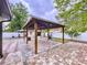 Beautiful backyard with large, brick-paved patio and open wooden pergola structure with grill at 7609 Barry Rd, Tampa, FL 33615