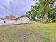 View of home with large backyard and mature trees at 7609 Barry Rd, Tampa, FL 33615