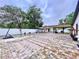 Expansive backyard patio with basketball hoop, shed, and pergola, ideal for outdoor entertainment at 7609 Barry Rd, Tampa, FL 33615