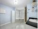 Bathroom featuring sleek tile floors, a jacuzzi, and a separate shower at 7609 Barry Rd, Tampa, FL 33615