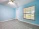 Bedroom featuring sleek tile floors, bright natural light, and a ceiling fan at 7609 Barry Rd, Tampa, FL 33615