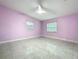 Bedroom featuring sleek tile floors, bright natural light, and a ceiling fan at 7609 Barry Rd, Tampa, FL 33615