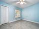 Bedroom featuring sleek tile floors, a ceiling fan and a double door closet at 7609 Barry Rd, Tampa, FL 33615