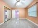 Bedroom featuring ceramic floors, natural lighting, ceiling fan and closet with mirrored doors at 7609 Barry Rd, Tampa, FL 33615