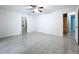 Spacious bedroom with tile floors, ceiling fan, and two doorways, ready for personalization at 7609 Barry Rd, Tampa, FL 33615