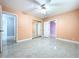 Bedroom with mirrored closet doors, ceramic floors, ceiling fan, and neutral colored walls at 7609 Barry Rd, Tampa, FL 33615