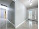 Welcoming entryway with decorative front door, tile floors, and modern light fixture at 7609 Barry Rd, Tampa, FL 33615