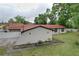 Exterior of the house showing the roof, the yard and some plants at 7609 Barry Rd, Tampa, FL 33615