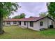 Charming single-story home featuring a well-maintained lawn and red-toned roof at 7609 Barry Rd, Tampa, FL 33615