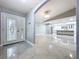 Bright foyer with tile floors, modern light fixture, and views to kitchen at 7609 Barry Rd, Tampa, FL 33615
