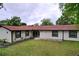 Well-maintained home featuring a large front lawn, fresh exterior paint, and updated windows at 7609 Barry Rd, Tampa, FL 33615
