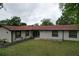 Well-maintained home featuring a large front lawn, fresh exterior paint, and updated windows at 7609 Barry Rd, Tampa, FL 33615