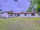 Charming one-story home with a well-manicured lawn and mature trees at 7609 Barry Rd, Tampa, FL 33615