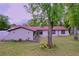 Inviting home exterior with landscaped yard and mature trees at 7609 Barry Rd, Tampa, FL 33615