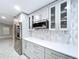 Kitchen featuring stone countertops and stainless steel refrigerator at 7609 Barry Rd, Tampa, FL 33615