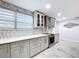 The kitchen area boasts a backsplash, modern appliances, and a bright and airy atmosphere at 7609 Barry Rd, Tampa, FL 33615