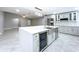 The kitchen showcases a large island with a wine cooler and stainless steel appliances at 7609 Barry Rd, Tampa, FL 33615
