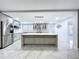 Bright, open kitchen features a large island, stainless steel appliances, and modern gray cabinetry at 7609 Barry Rd, Tampa, FL 33615