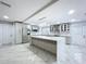 Modern kitchen with gray cabinetry, a large island, stainless appliances, and a mosaic backsplash at 7609 Barry Rd, Tampa, FL 33615