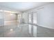 Spacious living room with tiled floors, modern lighting and french doors to pool at 7609 Barry Rd, Tampa, FL 33615