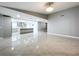 The open-concept living area showcases tile floors and a view of the modern kitchen, seamlessly connected for easy living at 7609 Barry Rd, Tampa, FL 33615