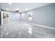 Spacious living room featuring ceramic tile floors, neutral walls, and natural light at 7609 Barry Rd, Tampa, FL 33615