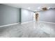 This living room features gray walls, tile floors, and a doorway to another room at 7609 Barry Rd, Tampa, FL 33615