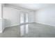 Spacious living room with tiled floors, modern trim and french doors to pool at 7609 Barry Rd, Tampa, FL 33615
