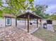 Covered patio area features paved brick and a ceiling fan, ideal for outdoor entertaining at 7609 Barry Rd, Tampa, FL 33615
