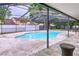 Screened-in kidney-shaped pool is ready for a relaxing swim at 7609 Barry Rd, Tampa, FL 33615