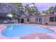 Inviting pool area featuring a screened enclosure, patio, and access to the home's exterior at 7609 Barry Rd, Tampa, FL 33615
