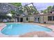 Inviting pool area featuring a screened enclosure, patio, and access to the home's exterior at 7609 Barry Rd, Tampa, FL 33615