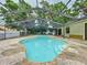 Enjoy the outdoors with this property's screened-in kidney shaped pool at 7609 Barry Rd, Tampa, FL 33615