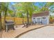 Backyard view highlighting the outdoor kitchen area with a grill and shed with outdoor seating at 7708 N Arden Ave, Tampa, FL 33604