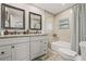 Bathroom with double sinks, granite countertops, and a shower-tub combination at 7708 N Arden Ave, Tampa, FL 33604