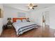 Bright bedroom featuring a queen-size bed, two side tables, and hardwood floors at 7708 N Arden Ave, Tampa, FL 33604