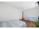 Bright bedroom with two beds, hardwood floors, and large windows at 7708 N Arden Ave, Tampa, FL 33604